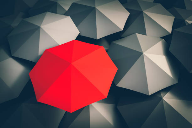 istock Red umbrella and many black umbrellas around 1044767942