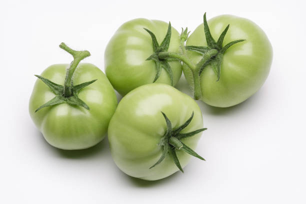 istock Green tomatoes isolated on white background. 1044769852