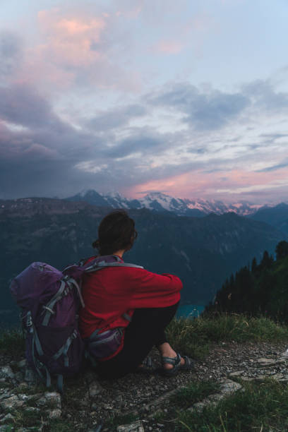 istock Woman with backpack sitting and looking at view 1044770508