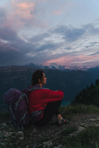 istock Woman with backpack sitting and looking at view 1044770552