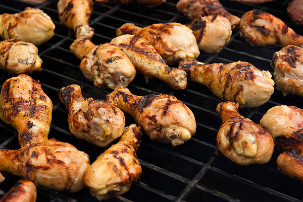 Chicken cooking on a grill stock photo