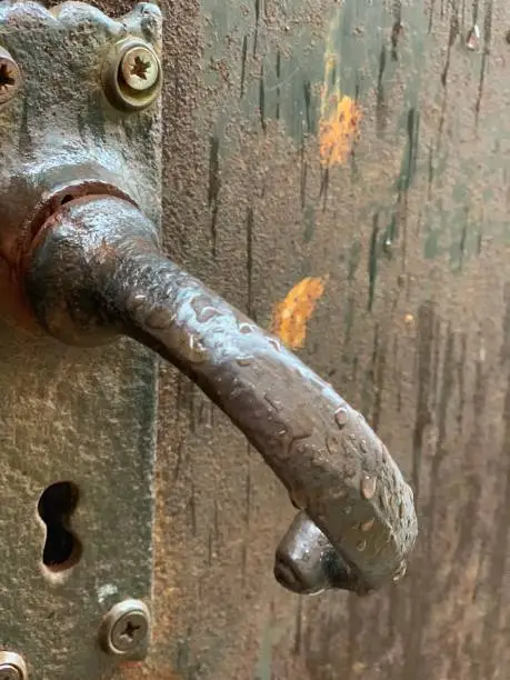 Captured this antique looking door handle at a angle to capture effect of the rain drops.