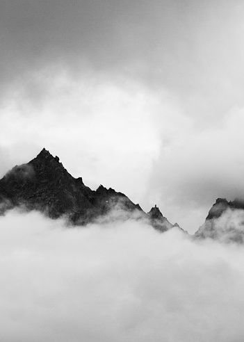 Kinner Kailash mountain range peeking through the heavy clouds