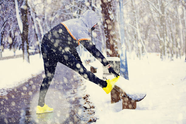 istock Sportsman stretching on a bench in strong winter time. 1044789882