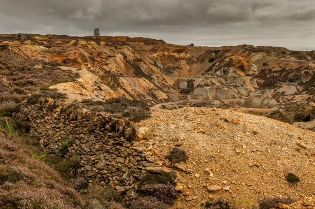 The orange and brown landscape of the disused Parys Mountain copper mine, Anglesey, North Wales.
