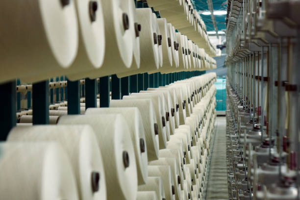 istock Industrial textile factory. Coils with threads in production.Fabric production . 1044795438