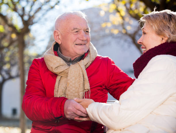 istock Mature couple talking in park 1044795630