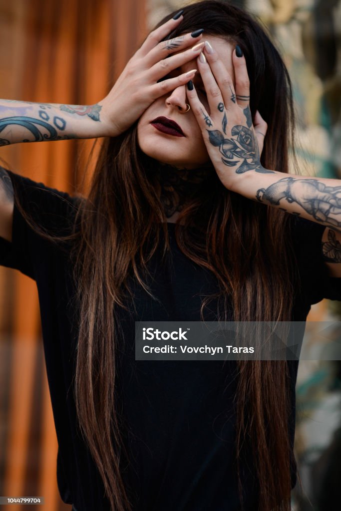 Beautiful Brunette Girl With Black Lips Tattoos And Piercing Stock Photo -  Download Image Now - iStock