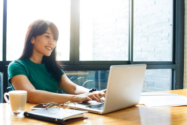 アジアの若きオーナー ビジネスの女性オンライン作業、オフィスでの作業プロセスを整理するノート パソコンでメールをチェックします。領域をコピーします。 - planning business person clothing well dressed ストックフォトと画像