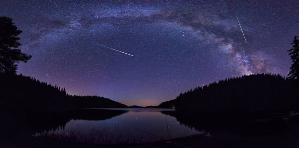Milky Way and the Perseids Long time exposure night landscape with Milky Way Galaxy during the Perseids flow above the Beglik dam in Rhodopi Mountains, Bulgaria meteor shower stock pictures, royalty-free photos & images