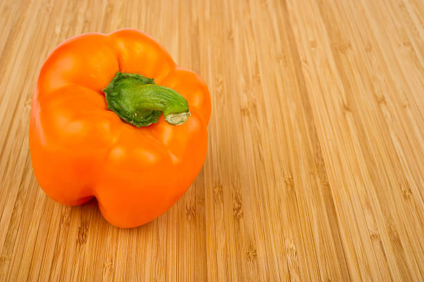 Orange Bell Pepper on Cutting Board stock photo
