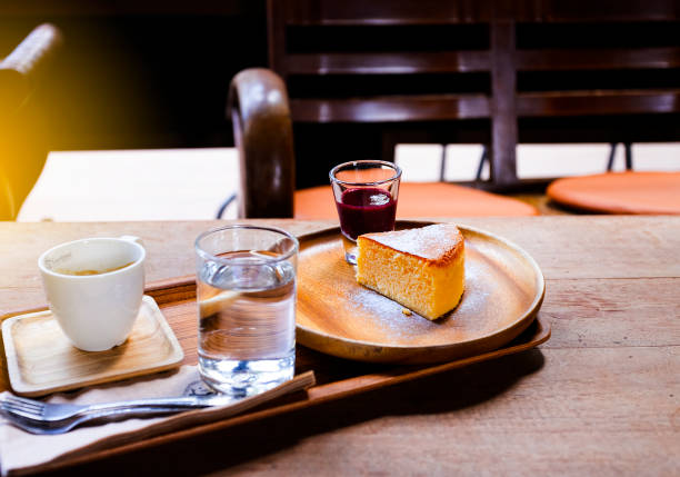 istock Black coffee in a white cup with bread and strawberry jam on a wooden table, suitable for a warm morning. 1044809316