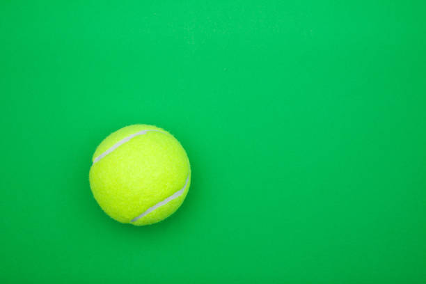 istock Tennis ball on green background with copy space 1044809362