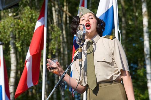 Enschede, The Netherlands - 01 September, 2018: A singer from 'Sgt. Wilson's army show 'doing their stage act with historic forties songs during a military army show.