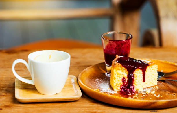 istock Black coffee in a white cup with bread and strawberry jam on a wooden table, suitable for a warm morning. 1044812462