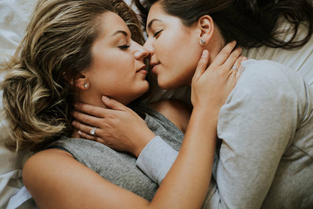 lesbian couple kissing in the morning - homosexual beautiful sensuality love imagens e fotografias de stock