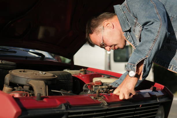 istock Adult Man looking his car engine 1044817004