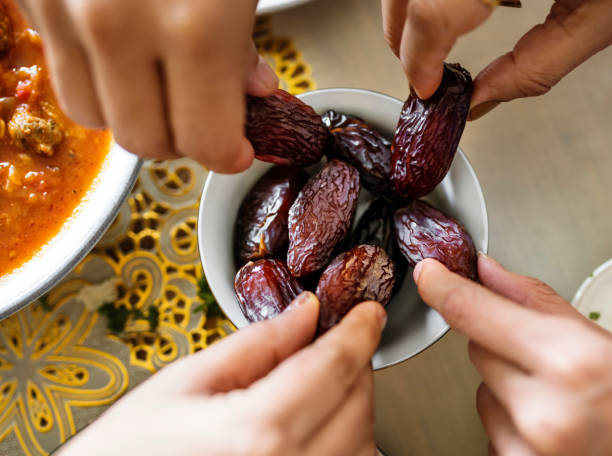 istock Middle Eastern family sharing and eating dates together 1044820424