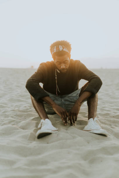 istock Man sitting at the beach 1044823698
