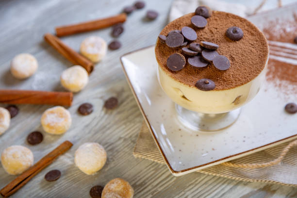 Close up view of beautiful elegant sweet dessert, tiramisu, served on the plate. Beautiful decoration, restaurant dish, ready to eat. Tea time, cozy atmosphere. Close up view of beautiful elegant sweet dessert served on the plate. Beautiful decoration, restaurant dish, ready to eat. Tea time, cozy atmosphere wedding cake close up macro stock pictures, royalty-free photos & images