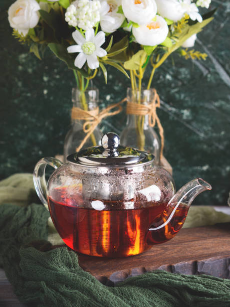 istock Hot tea in glass tea pot over green background 1044825024