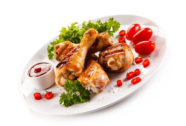 istock Roast chicken drumsticks on white background 1044828118