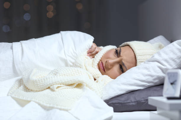 istock Woman suffering cold in a bed in winter 1044829812