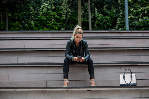 istock Young woman outdoor using a mobile phone 1044830206