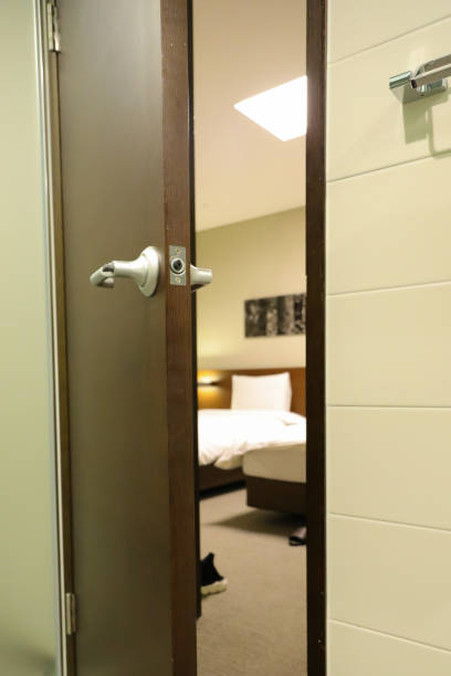 a half open door into bedroom interior as background stock photo