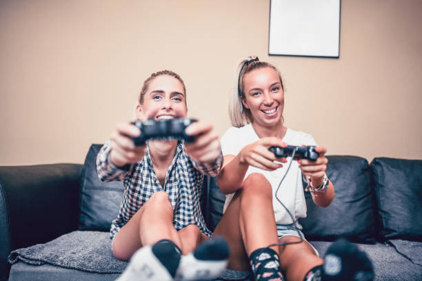 istock Young Lesbian Couple Is Playing A Videogame 1044832472