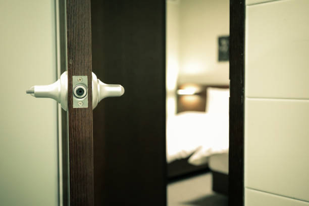 istock a half open door into bedroom interior as background 1044832842