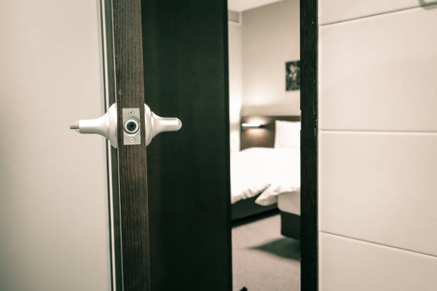 istock a half open door into bedroom interior as background 1044833180