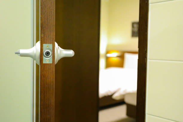 istock a half open door into bedroom interior as background 1044833214