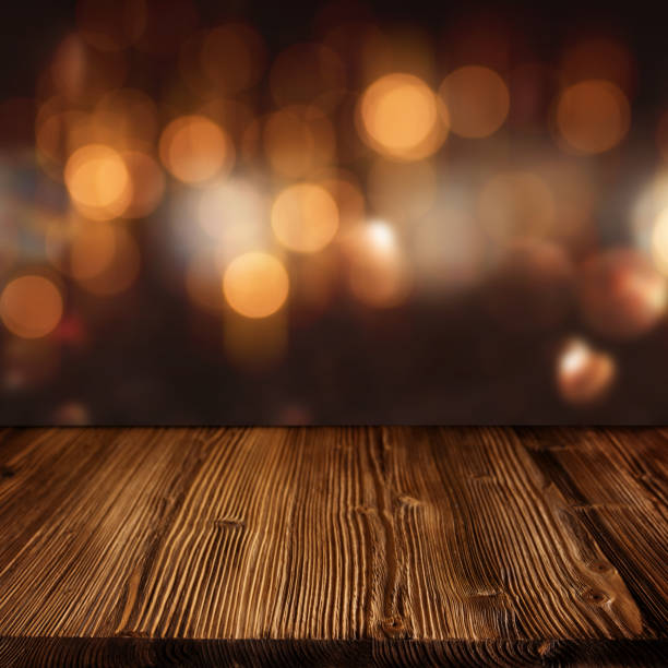 istock Celebratory bokeh background with wooden table 1044833584