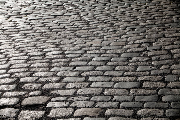istock Cobblestone street stone flooring. Background 1044834170