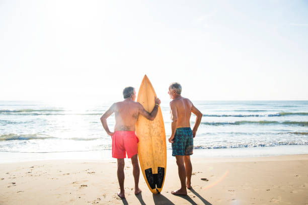 istock Mature surfers at the beach 1044837004