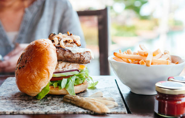 istock eef burger with grilled onion cheese, lettuce french fried 1044848244