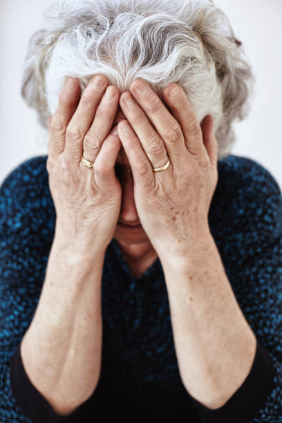 istock Old woman sitting on steps and crying 1044848342