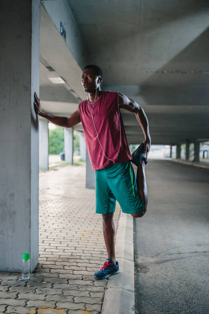 istock African American athlete stretching outdoors in urban city environment 1044851002