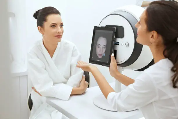 Face Skin Analyze. Cosmetologist Analyzing Woman Facial Skin At Cosmetology Clinic. High Resolution