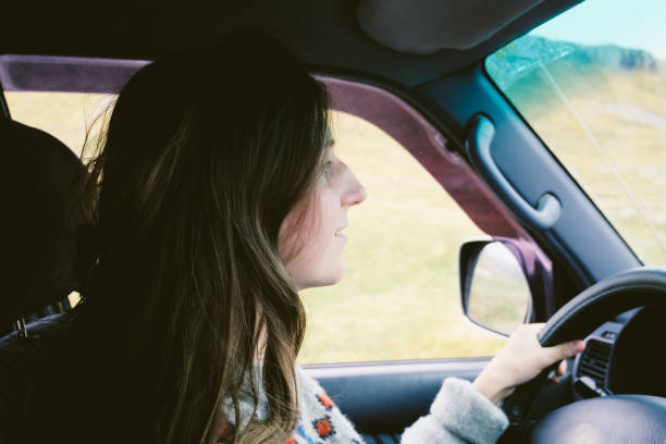 istock Woman driving car in Iceland 1044851282