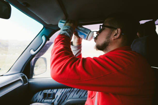 istock Man drinking water from bottle in the car in Iceland 1044851422