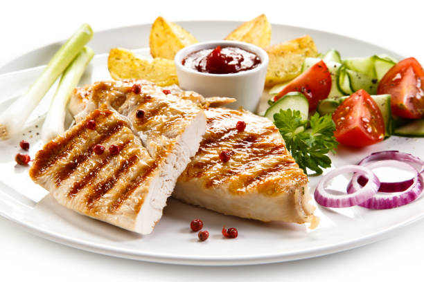 istock Grilled chicken breast and vegetables on white background 1044851606