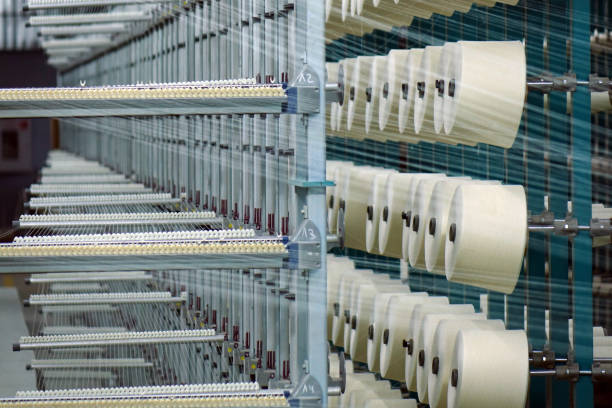 istock Industrial textile factory. Coils with threads in production.Fabric production . 1044856426