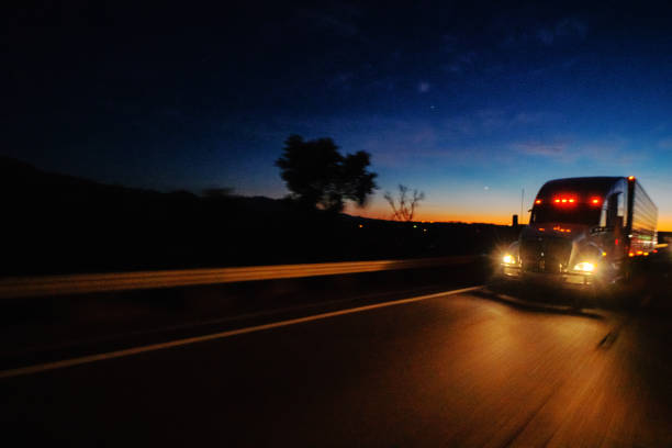 Big freight truck on the open highway in front of an amazing sunset