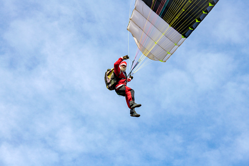 Senior Man as Santa Claus Paragliding in Snowless Mediterranean,Primorska,Julian Alps,Slovenia, Europe, Nikon D850