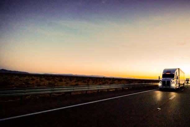 Big freight truck on the open highway in front of an amazing sunset