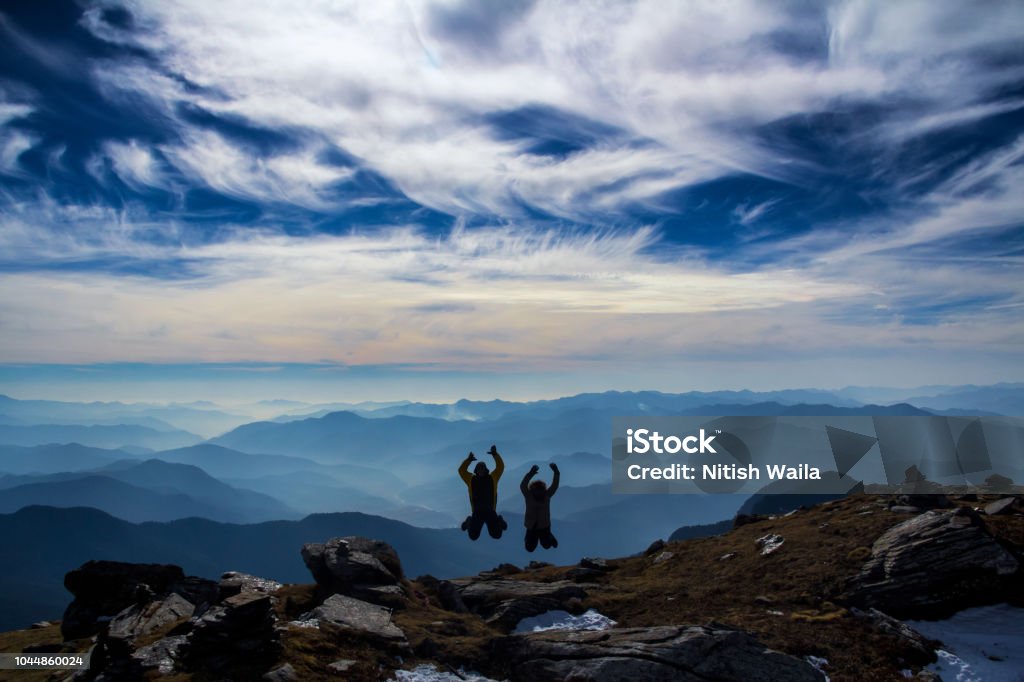 Jump to the summit of Kedarkantha Jump or leap of happiness is indeed what you feel at the top of a mountain Adult Stock Photo