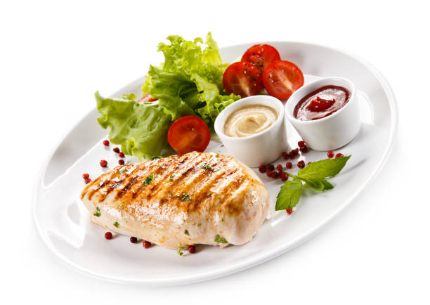 istock Grilled chicken breast and vegetables on white background 1044860516