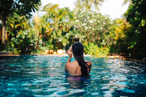 istock Young woman relaxing in the pool 1044866692